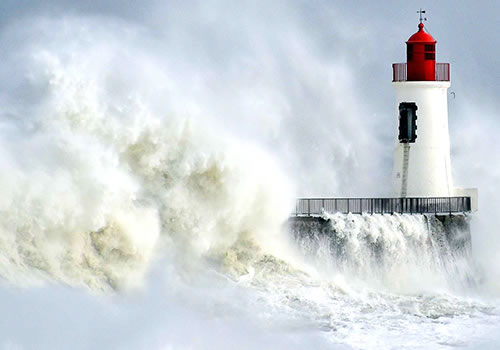 Vagues contre un phare en Bretagne